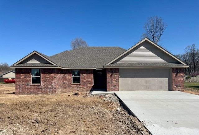Gorgeous home built by a custom home builder with an eye for detail! 1500 sq ft with 3 bedroom and 2 baths. Lots of extras including full brick, granite, fireplace, walk in closets, soft close cabinets, spacious covered patio, on a hard to find extra large lot. Builder to sod front and sides and seed backyard. Perfect open floor plan in this adorable small town. On the same street as the school! Don't miss the opportunity to own this new home!
