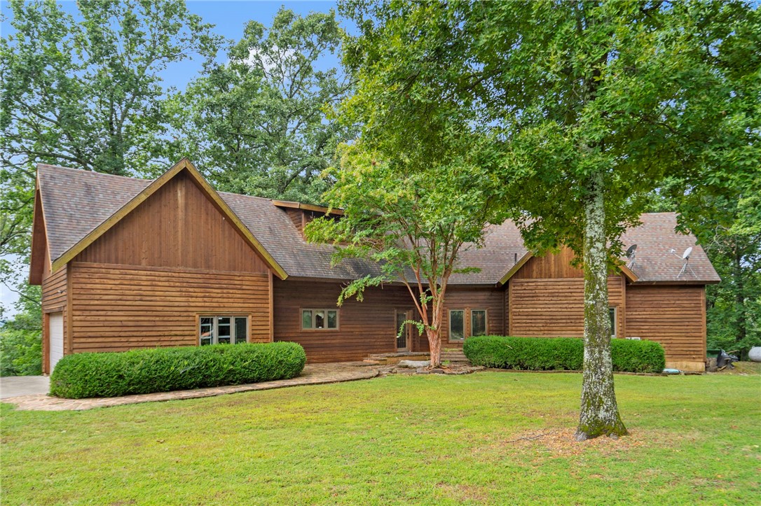 This beautiful cedar home, situated on over 20 acres, offers stunning 360-degree views of rolling hills, perfect for enjoying sunrises and sunsets. The property includes trails for outdoor adventure and can be a short-term rental. All personal effects can convey with the sale. Located just 7 miles from downtown Eureka Springs, and a short drive from biking trails, the Kings & White Rivers, and Beaver & Table Rock Lakes, this is an ideal retreat. Access is via County Road 114, a well-maintained 2-mile dirt road. The home features a bonus room upstairs and loft, and a private deck off the primary bedroom adding to its charm and appeal. A rare combination of peace, privacy, and adventure awaits. Don't forget to take advantage of the generous preferred lender credit being offered! Contact listing Realtor or your preferred Realtor for information to good to pass up!