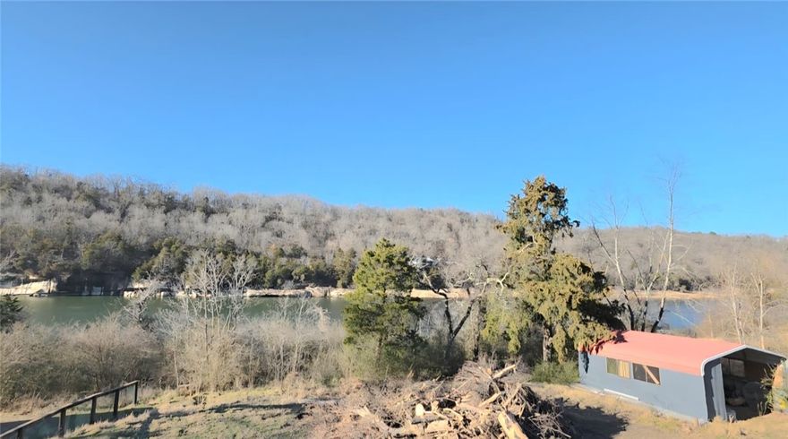 Nice 1-acre lot to build a home or place a mobile home, featuring two electric meters, septic, pump water on the property, and a beautiful lake view.