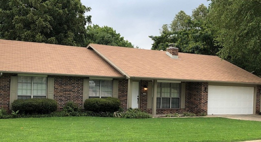 Great location in northeast Fayetteville accesses Root Elementary School. Nice landscaped lot in a quiet established neighborhood, just off Old Wire Road. This section of the street is one block long, ending in a cul-de-sac. FAUX-WOOD FLOOR IN LIVING ROOM, HALLWAY AND ALL BEDROOMS (no carpet), NICE BLINDS and PAINT. Open floor plan with three bedrooms and two full bathrooms, extra lighting, many windows, storage closets and ceiling fans throughout. Spacious living room with high ceiling is open to large dining, which is open to big kitchen. Kitchen has counter bar, flat-top range/oven, and lots of cabinets. Bonus area past kitchen has separate laundry closet. Fireplace in living room is encased in brick from floor to ceiling. Master suite has walk-in closet. Master bathroom and guest bathroom both have a nice vanity and full tub/shower. This home features a privacy-fenced back yard with covered patio and double enclosed garage.