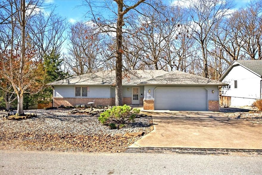 Well built older home that has been loved and cared for by owner. Sunroom off kitchen adds 160 sq feet. Roof is 2024, Heat Pump 2022, water heater 2026 and new trex type decking 2025 with new rails. Flooring done in 2018 in kitchen, family room and bath. Carpet in bedrooms only. Appliances convey; refrigerator, washer and dryer. Oak cabinets with extra storage in kitchen. Corian counters in excellent condition. Split floorplan. Propane fireplace in famiy room for cozy warm nights. Yard looks out to trees and a beautiful red japanese maple. Low maintenance yard for easy care. Major items are done. Home needs very little TLC and sits in a highly desired neighborhood in Bella Vista.This home is a perfect starter home , retirement home or rental; ready for the new owner. Close to shopping, banks and in central area of Bella Vista. Just enough space to relax and enjoy with not much upkeep. Flat yard for Fido and the kids. Small area under home has water heater. Move in ready