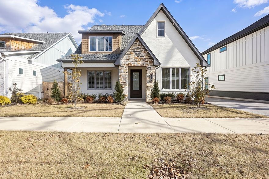 Custom designed like-new home within walking distance of world class museums, biking trailheads, and downtown square. Premium finishes throughout. Gourmet kitchen with large quartz island, walk-in pantry, commercial grade fridge-freezer, and connected dining room. Open layout living room with gas fireplace. Main floor also features the primary suite and an office/bedroom with attached full bath. Second floor features three bedrooms with two full baths and a second living/bonus room. Front and back patios perfect for downtown living. Landscaping with sprinkler system. Detached two car garage with extra parking space. Accessed by shared private alley off of NW A Street. Surrounded by a great neighborhood and walking distance to everything you need.