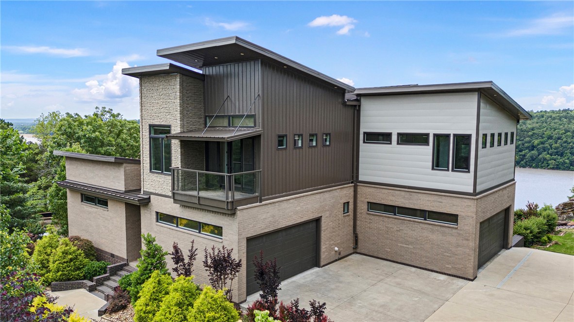 STUNNING MODERN MASTERPIECE WITH BREATHTAKING RIVER VIEWS!!! Experience living in this custom-built 3800 sq ft. modern home that perfectly blends sleek design and luxurious comfort. Perched to capture panoramic river views, this architectural gem offers an unparalleled lifestyle in a serene setting. Step inside to an open-concept layout that showcases soaring ceilings, clean lines, and expansive windows that flood the space with natural light. The chef's kitchen is the heart of the home-fully equipped with top-of-the-line appliances custom cabinetry, quartz countertops, and an large island perfect for entertaining. Designed with both relaxation and entertainment in mind, this home features a media room, ideal for movie nights or hosting guests. Retreat to the spacious primary suite where you'll awake up to stunning water views and enjoy spa-like luxury. Enjoy seamless outdoor living with a large covered deck, perfect for al fresco dining, morning coffee, or watching the sunset over the river.