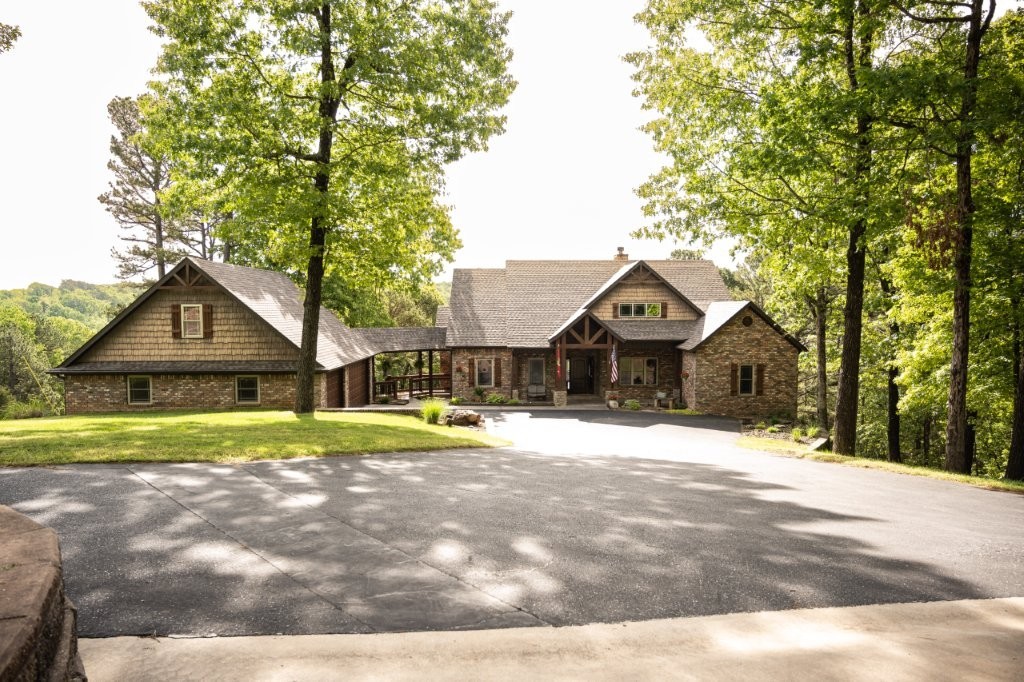 Nestled in Nature, this beautiful 4,495 sqft, 4 bedroom, with finished basement home sits on 6.3 wooded acres just minutes from Beaver Lake and 15 minutes from Rogers. The finished basement is an entire living space in itself with living area, small kitchen space, two bedrooms & two baths. Ideal for guest or in-law suite. The exterior of the home compliments the interior with a nice driveway and covered breezeway leading from the house to the garage. 36x40 Shop Building. Don’t miss out on this exceptional opportunity to own this extraordinary home.