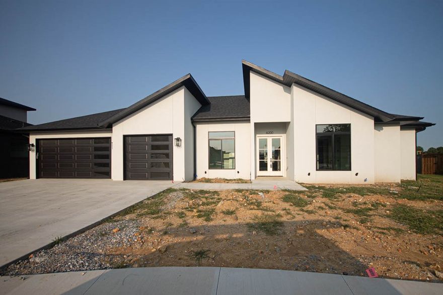 Modern one-story plan offers spacious kitchen-to-living area & boasts unequaled amenities & quality throughout! East facing home in the desirable gated community of Scissortail! Enjoy the bright, peaceful living area with black windows, tile linear fireplace & engineered hardwood floors with a natural finish. Kitchen with over sized island, quartz countertops, pot filler, walk in pantry & double oven! Hardwood floors throughout the home, custom beams, storage, security system, central vac & more! Large master suite with accent wall & spa like master bathroom. Tall ceilings, soaking tub, walk in shower with rain head, double sinks & luxurious master walk in closet! Study with custom beams & beautiful lighting & bonus room with custom beams and tons of natural light. Conveniently located within walking distance of the Bentonville Schools. Scissortail residents have access to TONS of community amenities including gated community, clubhouse, adult pool, family pool, exercise room, playground, firepit and sports court.