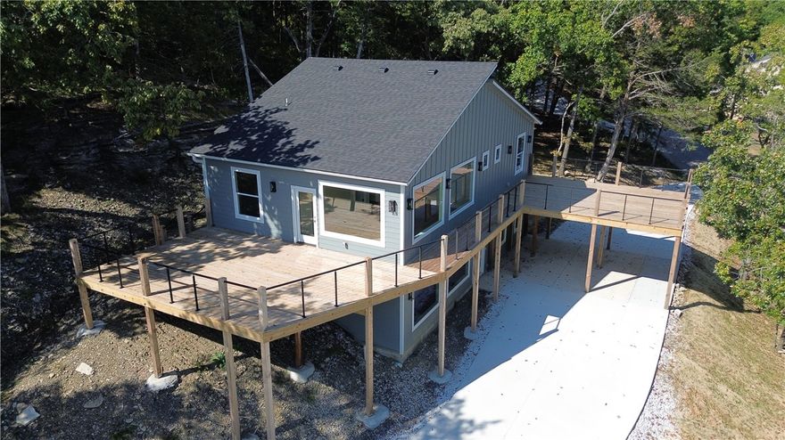 Experience modern lake living in this new home in Lost Bridge Village! Thoughtfully designed with clean lines, natural light, and seamless indoor-outdoor flow, this 4-bed, 2.5-bath home offers the perfect blend of comfort and craftsmanship with lake views that open in the winter, striking rock bluff features and a peaceful setting surrounded by nature. Enjoy the open floor plan, quartz countertops throughout, custom soft-touch cabinetry with pullouts, lazy Susan, under-cabinet lighting, and no carpet for easy maintenance, primary suite is located on the main level, with washer and dryer hookups available on both floors. Enjoy multiple outdoor living spaces, plenty of parking with an extended drive. Lost Bridge Village amenities include pool, pickleball courts, airstrip, easy lake access down the road and more. Enjoy both recreation and relaxation in one beautiful setting, situated on 0.56 acres, designed for low-maintenance, this home perfectly combines modern living and natural beauty if it's an air bnb or home!