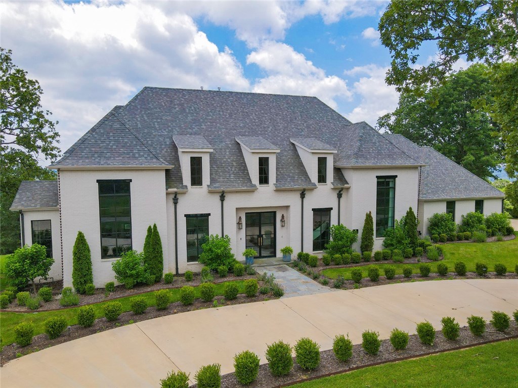 Luxurious Custom Built Estate home sitting on 5 acres. Stunning 5941 heated sq ft open floor plan featuring 5 Bedrooms, 5 full baths and 2 half baths. Gorgeous views from your own infinity pool and outdoor kitchen. Amenities abound including, cathedral ceilings, abundance of natural, gourmet kitchen with built-in coffee maker, enormous walk-in pantry, marble floors, and large walk-in closets. Master bath includes oversized walk-in shower and soaking tub. Custom sound and lighting throughout this gorgeous home. 3 car garage. One of NWA's finest estates. This truly is a Must See!