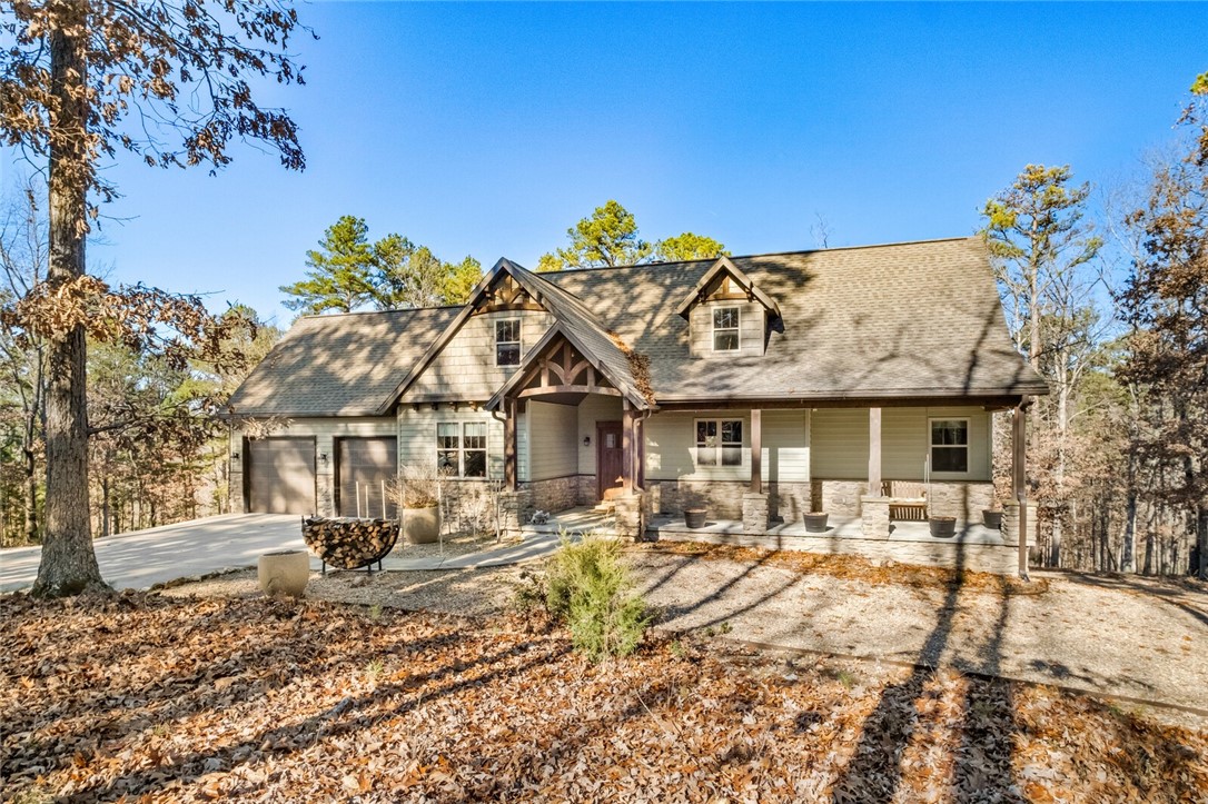 Beaver Lake area home nestled on nearly 4 private acres & less than 1-mile to Ventris boat ramp! Home has 3 fantastic outdoor living spaces...enjoy a seasonal lake view from the screened deck, an abundance of trees & nature from the spacious front porch or unwind in the patio hot tub. The great room boasts a Rumsford fireplace & the eat-in kitchen has ample storage. Through the oversized pantry, you'll find the office nooked perfectly to appreciate forest views. Main floor primary bedroom & guest bedroom both walk-out to the deck. A guest bath & laundry room finish off the level. In the finished, walk-out basement you'll find 2 add'l. bedrooms, a family room plumbed & ready for a wet-bar/kitchenette & another full bath. The concrete safe room would also make a cool wine cellar! Bonus features include a hard-wired home generator plus 24x32 detached garage. 130' at rear of parcel is adjacent to the Corps line. Built in 2014, this home is in good condition ready for a new owner to embrace rural, lake area living!