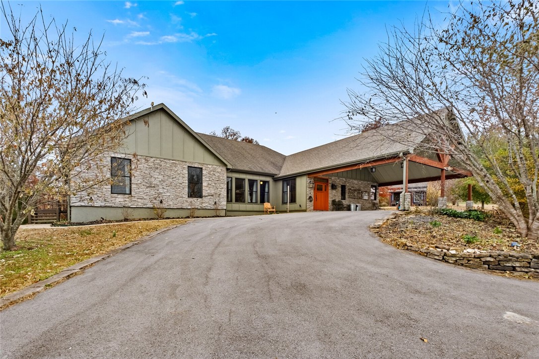 Located just 15 minutes from Fayetteville, this desirable location allows for a serene rural lifestyle without sacrificing city amenities. The sprawling 25 acres of land present limitless possibilities, from establishing your own private sanctuary to indulging in outdoor recreational activities or even cultivating your own hobbies. Possible room for development! With ample space and thoughtful design, this home seamlessly combines elegance and functionality. For those who enjoy working on projects or have a penchant for collecting, a large shop building is available, allowing you to pursue your passions and hobbies. Large 3rd bedroom could easily be redesigned into an additional 2 bedrooms with bathroom. Additional parcel 001-13994-000 included in the acerage.