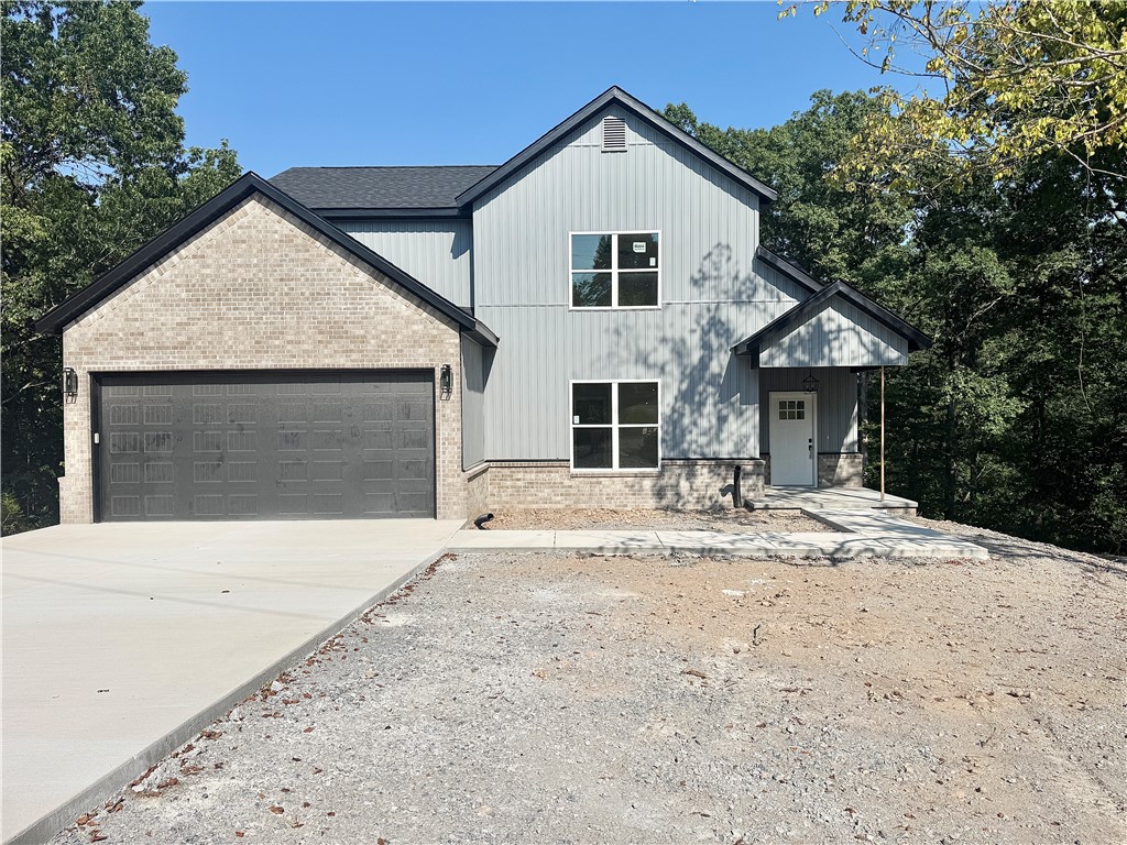 Gorgeous new construction home nestled in Bella Vista. Centrally located minutes from shopping, restaurants, and schools. Enjoy sitting on your covered deck enjoying this amazing lot, all the mature trees and privacy. Great home with fantastic layout, tray ceilings throughout and large rooms. Secondary bedroom on the main level. Large living room with beautiful gas fireplace, open floorplan LVP flooring on the main level and views of the mature trees. Kitchen has custom wood beam with vaulted ceiling, granite countertops, stainless steel appliances, large eat-in kitchen area and pantry. Large master bedroom with LVP flooring and spa like master bathroom has double sinks, soaking tub, walk-in tile shower with bench and large walk-in closet. Secondary bedroom on the second floor, large bedroom upstairs with extra storage and large bonus room for all your needs! Relax on the covered deck with stairs down to the backyard overlooking the backyard and views of the mature trees.