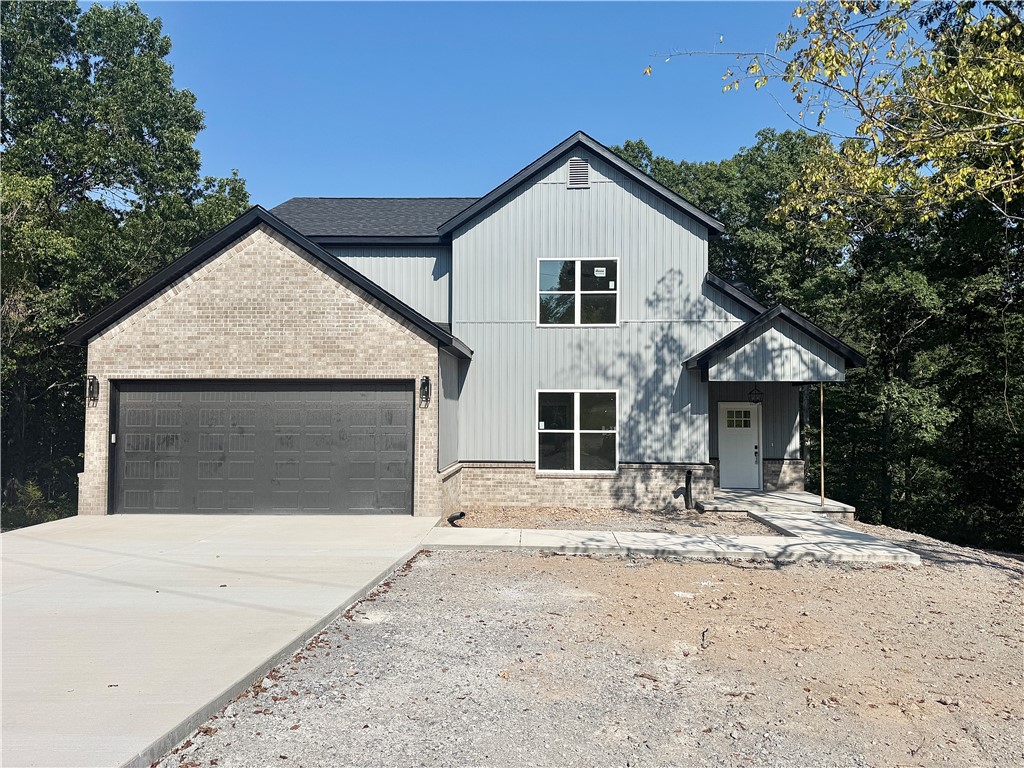 Gorgeous new construction home nestled in Bella Vista. Centrally located minutes from shopping, restaurants, and schools. Enjoy sitting on your covered deck enjoying this amazing lot, all the mature trees and privacy. Great home with fantastic layout, tray ceilings throughout and large rooms. Secondary bedroom on the main level. Large living room with beautiful gas fireplace, open floorplan LVP flooring on the main level and views of the mature trees. Kitchen has custom wood beam with vaulted ceiling, granite countertops, stainless steel appliances, large eat-in kitchen area and pantry. Large master bedroom with LVP flooring and spa like master bathroom has double sinks, soaking tub, walk-in tile shower with bench and large walk-in closet. Secondary bedroom on the second floor, large bedroom upstairs with extra storage and large bonus room for all your needs! Relax on the covered deck with stairs down to the backyard overlooking the backyard and views of the mature trees.