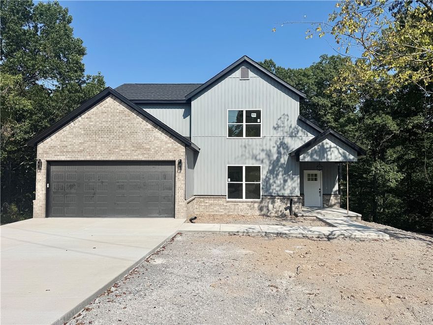 Gorgeous new construction home nestled in Bella Vista. Centrally located minutes from shopping, restaurants, and schools. Enjoy sitting on your covered deck enjoying this amazing lot, all the mature trees and privacy. Great home with fantastic layout, tray ceilings throughout and large rooms. Secondary bedroom on the main level. Large living room with beautiful gas fireplace, open floorplan LVP flooring on the main level and views of the mature trees. Kitchen has custom wood beam with vaulted ceiling, granite countertops, stainless steel appliances, large eat-in kitchen area and pantry. Large master bedroom with LVP flooring and spa like master bathroom has double sinks, soaking tub, walk-in tile shower with bench and large walk-in closet. Secondary bedroom on the second floor, large bedroom upstairs with extra storage and large bonus room for all your needs! Relax on the covered deck with stairs down to the backyard overlooking the backyard and views of the mature trees.