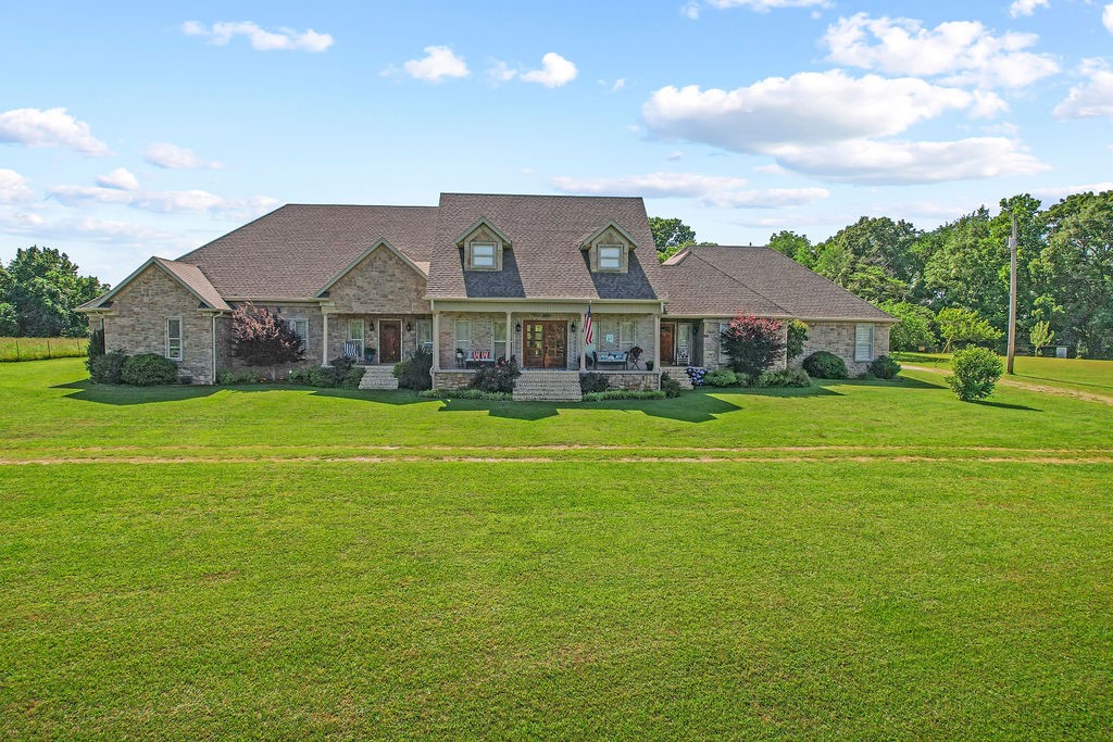 Unique opportunity in Northwest Arkansas! At 5600 square feet, this custom built home on a small acreage is perfect for a large family. This home has a true country feel yet is only a couple of minutes off of 49 and a few miles south of Fayetteville. This home features tons of amenities and space with a split floorplan featuring two en suites. The majority of the square footage is on the main level with bedrooms on the lower floor. There is a massive kitchen overlooking a large dining area and living room and features tranquil vistas into the private wooded backyard. This home sits on a dead end road making this a private sanctuary for a big family! It also has plenty of room for your vehicles and toys with two separate enclosed shop areas.