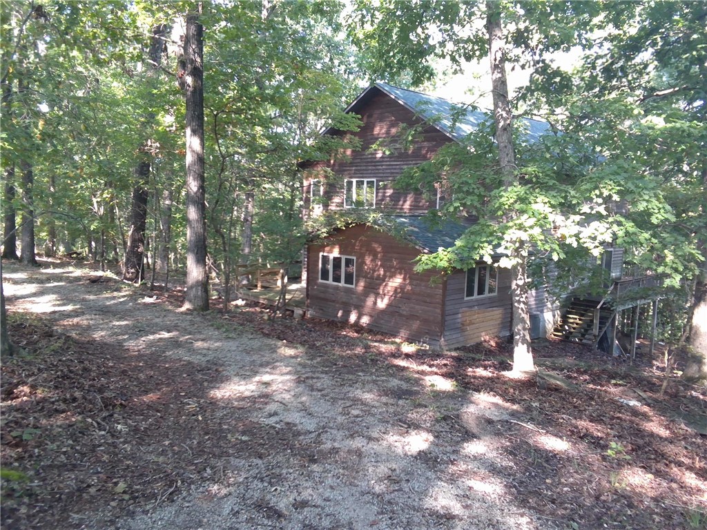 Over 11 wooded acres, this 2-bedroom, 2-bath cabin offers the perfect balance of privacy and rustic charm. Step inside to an inviting open-concept floor plan that fills the home with natural light and warmth. A full unfinished basement provides endless potential for additional living space, storage, or a workshop. Relax and enjoy the peaceful surroundings from the expansive wrap-around deck, ideal for entertaining or simply soaking in the beauty of nature. A convenient circle drive completes this rural retreat, making access easy year-round. Whether youāre seeking a weekend getaway or a full-time residence, this property is a true woodland escape.