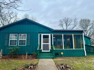 Check out this beautiful home..If you love color, this is the house for you! It sits on two large city lots conveniently located in the heart of Russellville. It has two living areas, 3 bedrooms, two full bathrooms, a dinning room, and a spacious utility room. This home had been immaculately kept and features beautiful tile and granite countertops, and very nice cabinetry in the kitchen. You are going to love the cheerfully painted screen porch! Come take a look and imagine how you could make it your own. Call for your showing today!