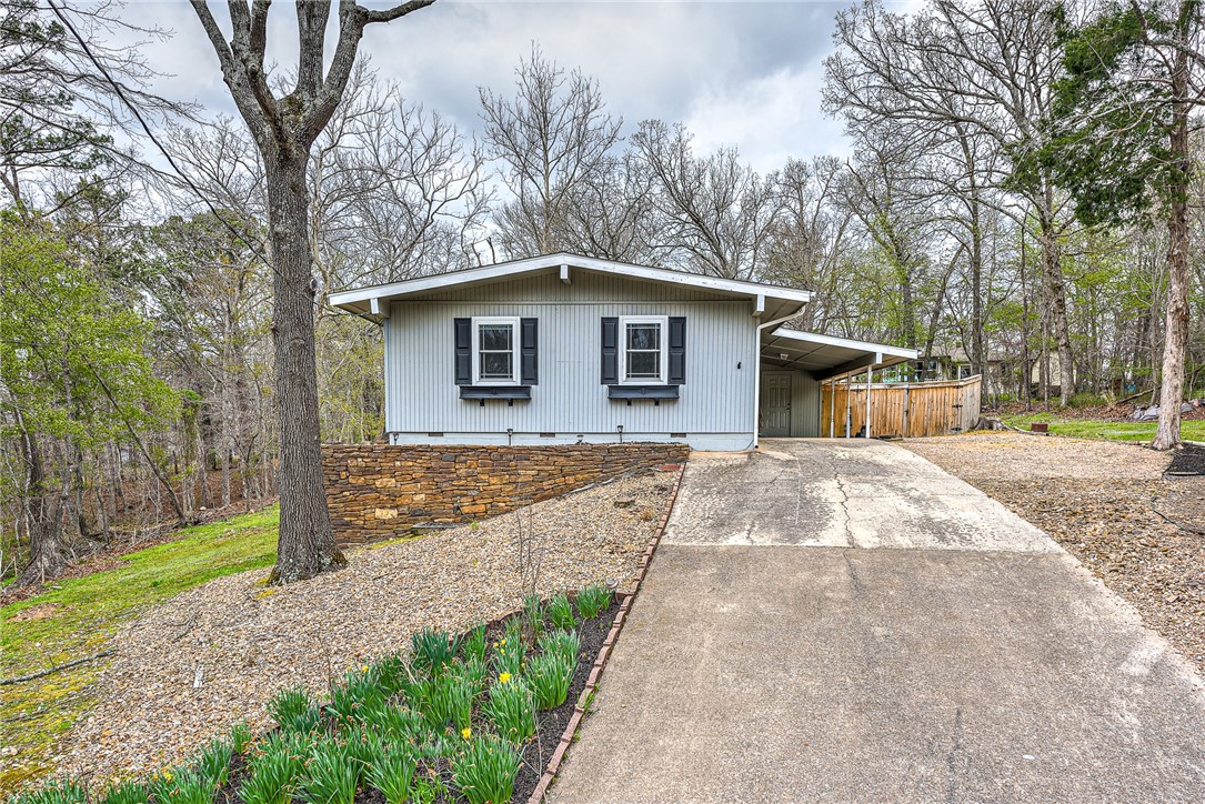 Looking for a cottage in the woods? This home has been updated with new roof and chimney, new carpet, kitchen appliances and complete bathroom overhaul in the last 2 years. With a beautiful screened in porch you can enjoy the beautifully landscaped outdoor space most of the year. Extra storage underneath the house as well as in the backyard shed. Less than .5 miles to the Back 40 Trailhead at Blowing Springs.