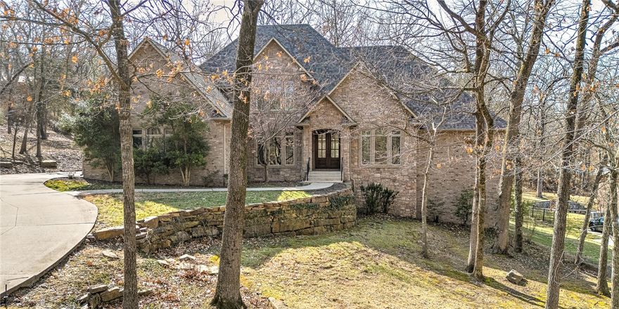 Luxurious home located in one of the most desirable neighborhoods in Fayetteville--just minutes to the Razorback Stadium, Bud Walton Arena and all that the University of Arkansas has to offer! This beautifully designed home with high end finishes has a feeling of being warm & cozy with all the natural light from the gorgeous windows throughout the house and lovely woodwork. The interior features an open floor plan, hardwood floors, custom cabinets, kitchen island, formal dining, designated office, plantation shutters and spacious walk-in closets throughout--just to name a few. The exterior was meticulously planned out with the screened-in back porch, wired with sound to enjoy the breathtaking view of the 1.09 acre wooded yard. The front lawn is professionally manicured with shrubbery, mature trees, a retaining wall, and a circular driveway. No other neighborhood offers similar peace, quiet and privacy while being so close to the excitement of Fayetteville!