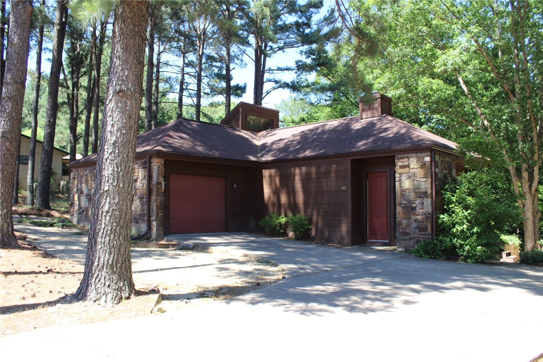 Unique floorplan in this custom home with high living room ceiling and lots of windows for a wooded view and a bit of winter lakeview too! It has 2 Bedrooms and 2 Bathroom and a Separate formal dining area that could be an office. Nice rear patio is private. Quality windows and 2 exits to the patio. Workshop area is in the basement.