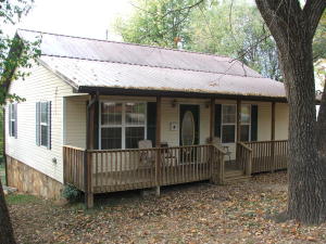 Neat 2 BR cottage with covered porch and metal roof. Remodeled kitchen. Other recent upgrades include CH&A, some wiring & all plumbing,paint, etc. Need to look this gem over for under $75,000!