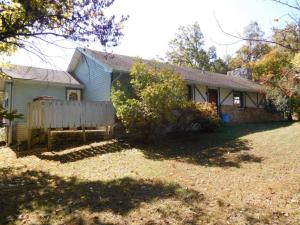 English cottage style home in lovely wooded 3.7 ac setting w/large stocked pond only 7 mi from town. 2 or 3 BR, 2BA, great room w/cathedral ceiling and beautiful stone wood burning fireplace, 24x30 metal garage/shop building great for the hobbyest.