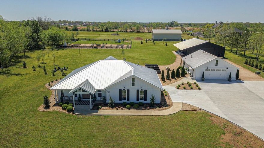 Nestled on +/-2.99 flat acres in heart of Bentonville, this exceptional estate offers the perfect balance of luxury, privacy, and versatility- minutes from Pinnacle Hills, Walmart Home Office, and Downtown Bentonville. Extensively remodeled property just outside city limits with privacy. The meticulously designed primary residence features custom craftsmanship, professional gas range, premium appliances, and seamless indoor-outdoor living. James Hardie siding, designer closets, and extensive built-ins add style and function. A fully equipped guest house provides space for guests, or income-bearing opportunities.  Black metal building could serve as an event venue, showroom, or workshop, with a ½ bath and durable metal roof. A 26kW Generac generator & built-in storm shelter offers peace of mind. Professionally landscaped grounds enhance the natural beauty. A rare opportunity for estate-style living with urban convenience in one of Bentonville’s most sought-after locations. 797 SF guest house incld in total heated SF