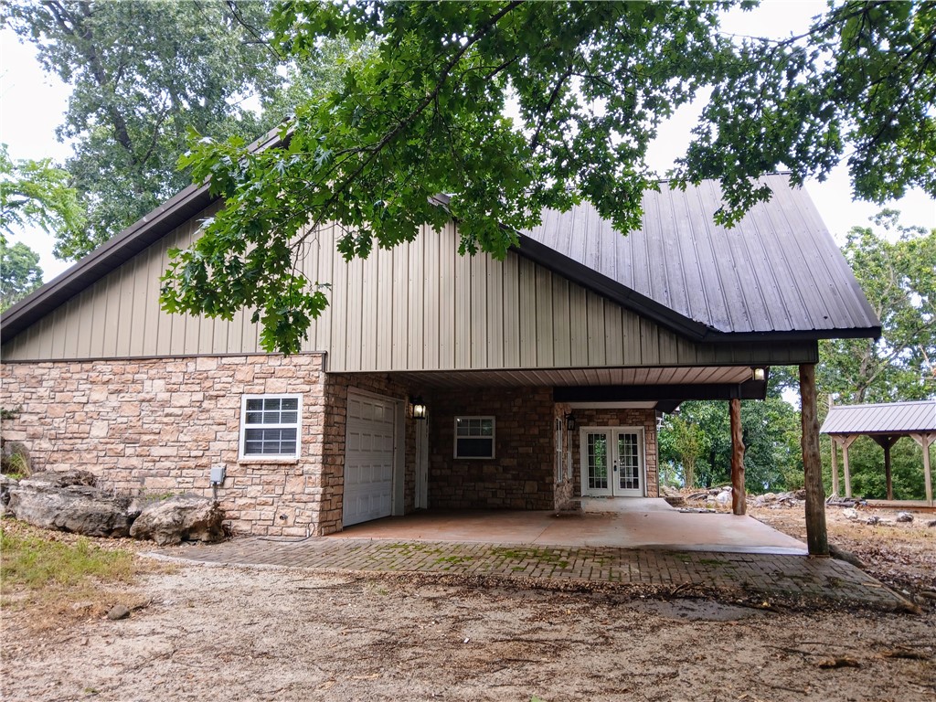 Here's your opportunity to own 33 acre mountain top with spectacular views of Table Rock Lake. Quick drive down to the public boat launch is a 5 min drive to the beautiful Table Rock RV Resort. This secluded property offers a gated entrance down the tree lined private drive. Ozark rolling hills will lead home to this gorgeous 3 bedroom, 2 bath Rustic home. Inside you'll find an open floor plan, cathedral ceilings and large picture windows facing what could be an ahh inspiring view of the lake with minimal clearing. Loft area opens to a walk out porch at the upper level perfect for a home office or study. Separate shop building is on slab concrete, 54 X 24 with 3 separate rooms. An additional concrete pad has endless possibilities for additional outbuildings, raised garden or lean too for animals. Mobile Home that was once in place has been removed, water capability remains in tact. Private well and no restrictions. Make a call today and fall in love with the serene seclusion tomorrow. 30 Minutes to Branson MO