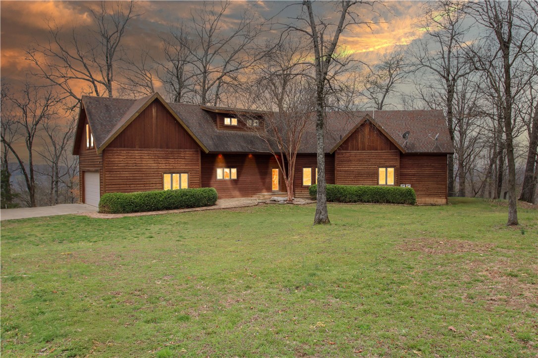 This beautiful cedar home, situated on over 20 acres, offers stunning 360-degree views of rolling hills, perfect for enjoying sunrises and sunsets. The property includes trails for outdoor adventure and can be a short-term rental. All personal effects can convey with the sale. Located just 7 miles from downtown Eureka Springs, and a short drive from biking trails, the Kings & White Rivers, and Beaver & Table Rock Lakes, this is an ideal retreat. Access is via County Road 114, a well-maintained 2-mile dirt road. The home features a bonus room upstairs and loft, and a private deck off the primary bedroom adding to its charm and appeal. A rare combination of peace, privacy, and adventure awaits. Don't forget to take advantage of the generous preferred lender credit being offered! Contact listing Realtor or your preferred Realtor for information to good to pass up!