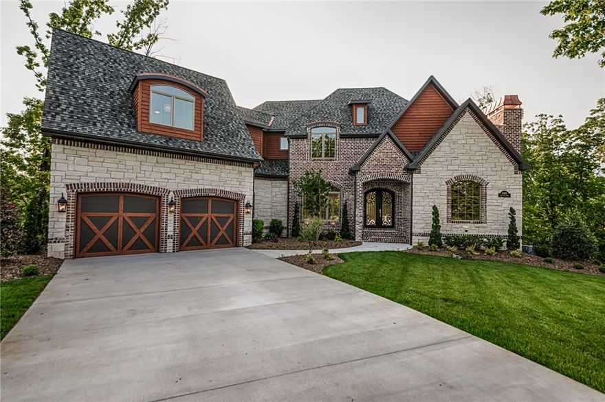 This is an absolutely amazing home on a 2 acre lot sitting in a cul-de-sac. Its many features include double ovens, hand scraped real wood floors, 4 fireplaces, 2 living rooms, 2 full kitchens, up to 6 bedrooms, 5.5 bathrooms, beautifully exotic granites, wet bar, coffered, vaulted and soaring ceilings, HUGE master suite, 2 separate oversized 2 car garages(4 total).  Downstairs could be great mother in law quarters(or teenage home) complete with its own kitchen and parking.  Amazing covered deck, fire pit