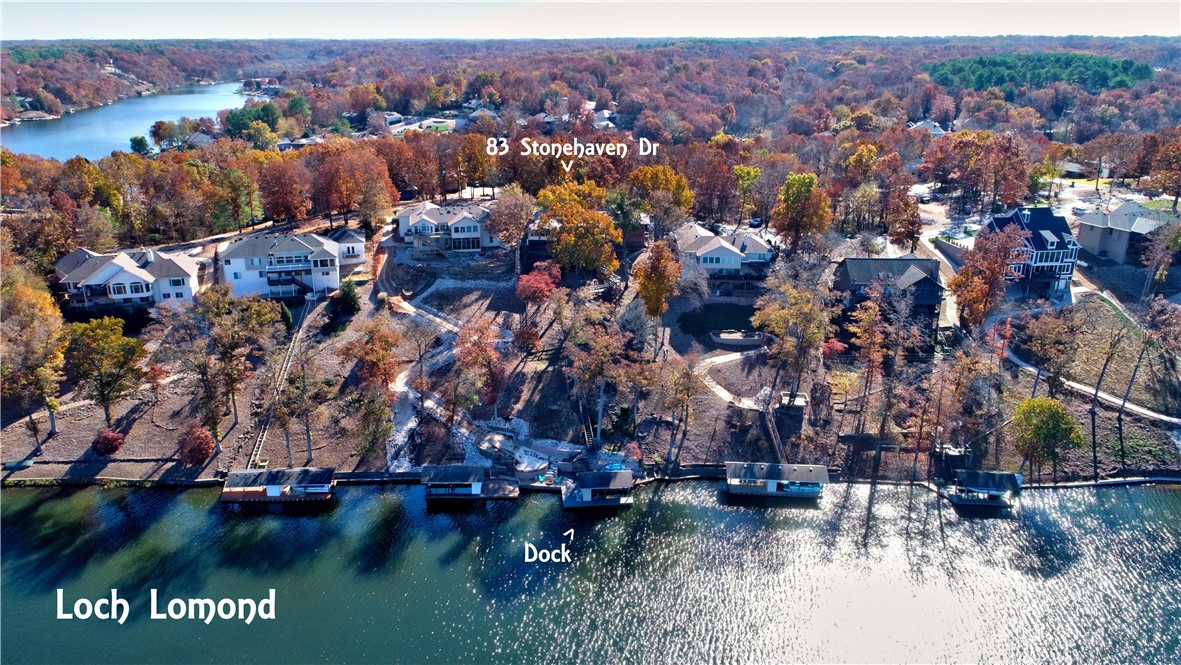 Beautiful lake front home w/private boat dock on Lake Loch Lomond!! Incredible views of the lake make this one extra special! This tastefully updated 4/bed 3/bath home has new paint & lights throughout, new hardware & new interior doors. Fabulous 4 seasons room w/perfect views of lake on main! Lower-level walkout w/2 bedrooms, 2nd living & kitchen, huge storage area & workout room. Several outdoor decks & screen porch overlooking the lake make for fabulous spaces to relax & dine. Private dock is totally refreshed w/a brand new retention wall, new steps, improved sea wall, firepit, increased living space, all new rock & landscaping. Decks, fence, & stairs to lake were all resurfaced & stained. New roof in 2020 & new air conditioners in 2021! Full size trees added to provide additional privacy. Three car garage & circular drive offer plenty of parking. Loch Lomond is Bella Vista’s largest lake, offering motor boating, great fishing, paddle boarding, dining, etc. True lake living w/quick access to town.