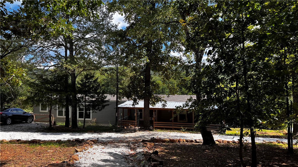 Very nice, newer, modular home with 3 bedrooms & 2 bathrooms that sits on 1.15 beautiful acres. Enjoy country living with this adorable, move in ready home that is on a paved road about 30 minutes away from Fayetteville. Luxury Vinyl flooring with wood look throughout. Open floor plan with trendy and modern looking kitchen with large island, pantry for additional storage, and eat-in area. Home has a master suite with a stand up shower, soaking tub, double vanity and spacious walk in master closet. Outside you will find a fenced side yard that is perfect for your pets, mature trees and stunning views off the covered front deck! Come and see this home while it is still available.