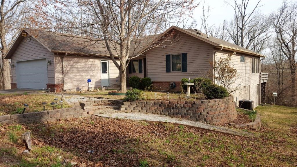 MOVE IN READY! Pre-inspected 1,678 ground level, 23X12 unfinished heated/cooled workshop/basement. Security motion lights & alarm system. Open floor plan, 3 bed, 2 bath, laundry, Sunroom off LR, BR and porch. Spacious cabinets & countertops. Gas fireplace, cathedral ceiling, full deck, office, laundry, garage. Extra lot (.29 ac) next door, included. Private circle drive. Home Warranty with pre-certified HVAC. Well kept quite neighborhood.