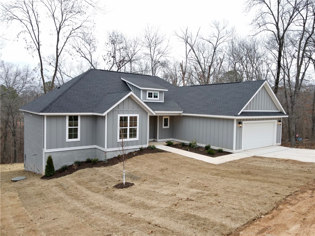This gorgeous new construction home has a perfect layout both for entertaining and a seamless flow of everyday living. This stunning open floor plan features a split design w/a primary ensuite on one side & and 3 additional bedrooms on the other. Upgraded 3cm quartz counters, beautiful hardwoods throughout & tile work add touches of luxury and charm to this home! You will appreciate the custom home finishes that set this spec home apart from others in the area. Come home & kick your shoes off in the mud room, drop your socks into the laundry room, and use the direct access into your primary bedroom to pick out your loungewear. A large walk-in pantry off the kitchen allows tons of storage. The kitchen features soft-close cabinets and drawers that complement the serenity of the space. Only a quick jump to "The Back 40", Lake Norwood and 15 minutes to the historic Bentonville square. This one set to be completed first of Dec 2024. Ready for its first owners!
