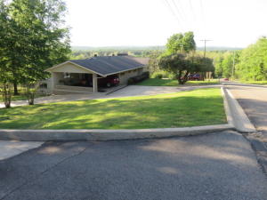 FIRST TIME ON THE MARKET---SUPERIOR CONSTRUCTION, CUSTOM BUILT with gorgeous views, manicured lawn, and phenomenal floor plan. This 4 bedroom offers 3 family rooms, sun porch, craft room, safe room, 2 kitchens, loads of built-ins throughout! 2 car garage plus 2 car carport! 3 water heaters. Beautiful lot to the north of the house conveys. Close to down town, the university, public schools---excellent location! This dwelling offers a mother in law quarters--(the lower level)! The floor between the levels is solid concrete--not wood subflooring. Lower central heat system is inoperable. Mineral rights do not convey.
