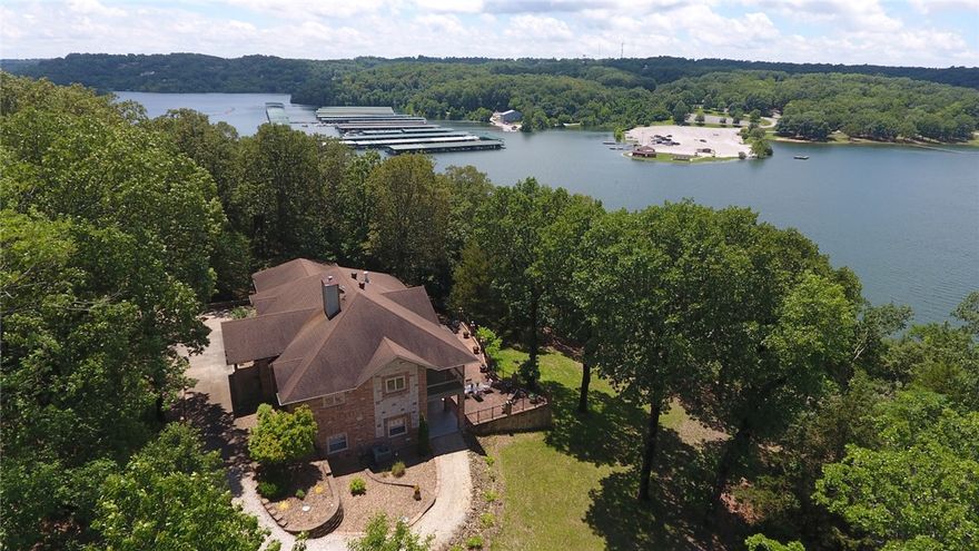 Custom home, quality throughout.  This is the best built home I have seen.  The custom cabinets, high efficiency appliances and quartz countertops are just a few of the items that make this home special.  Includes 5 plus acres, private boat dock, and over 1000 feet of Beaver lake frontage.  The walkout lower level leads to a large brick patio, well suited for large families or parties.  Located within 20 minutes drive of Rogers in central part of Beaver Lake.