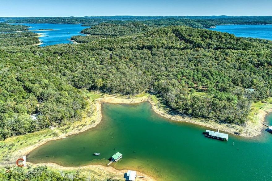 Lakefront Opportunity on the North Shore of Beaver Lake. Approximately 10.17Acres with 770’ of Corps Frontage. Property is gently sloping, with a low Corp Line. Fantastic 5 Slip Community dock fully owned by seller conveys with the Sale, Featuring 212x28’ slips, 12x20’ slip with lift, 12x16’ slip with lifts for wave runners, 12x12’slip, large covered lounge area and 12x16’ swim Platform, Solar electric. 80x30’ Insulated Shop Building and small 1970’s home sold as-is.