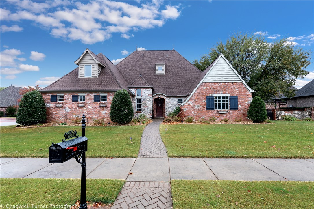 European chateau style home near Bentonville business district, Walmart home office, Elm Tree Elementary and Ardis Ann Middle School. Sit by the fire in the massive stone fireplace and sip hot chocolate or your favorite glass of wine. Chefs kitchen with JenAir gas range, beautiful low maintenance stained concrete floors on lower level. And don't worry about storms! You only need to go to the garage to get in the underground storm shelter! Two bedrooms on main level including huge primary suite. New roof August 2020.