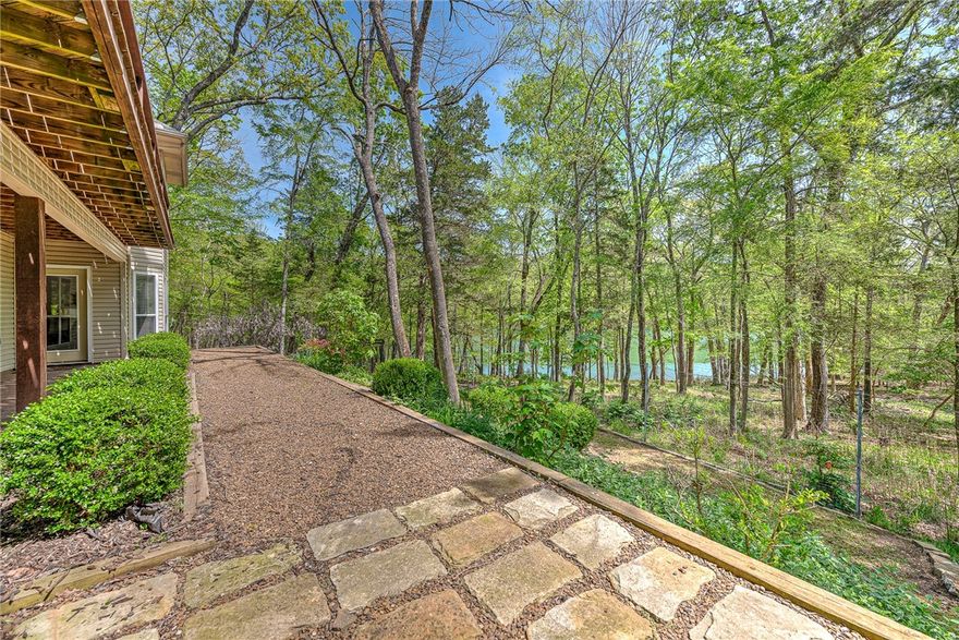 Welcome to your private oasis on the shores of pristine Beaver Lake! Nestled in the Lost Bridge Village community, this beautifully maintained home blends lakefront luxury & modern updates. Whether you’re seeking a full-time residence, vacation escape, or high-performing short-term rental, this property delivers. Step outside and you're just steps from the water’s edge—perfect for swimming, kayaking, or launching your next adventure. Panoramic lake views grace the main living spaces, and expansive decks invite you to relax or entertain against the serene backdrop. Inside, the home features a bright, open floor plan with thoughtful updates, including a new roof (2024) and HVAC system for peace of mind and efficiency. Stylish finishes, natural light, and cozy gathering spaces make it both inviting and functional. Residents enjoy a private clubhouse, seasonal pool, and community boat launch—ideal for making the most of lake life. Proven Airbnb success makes this home turnkey-ready for investors and lake lovers alike.