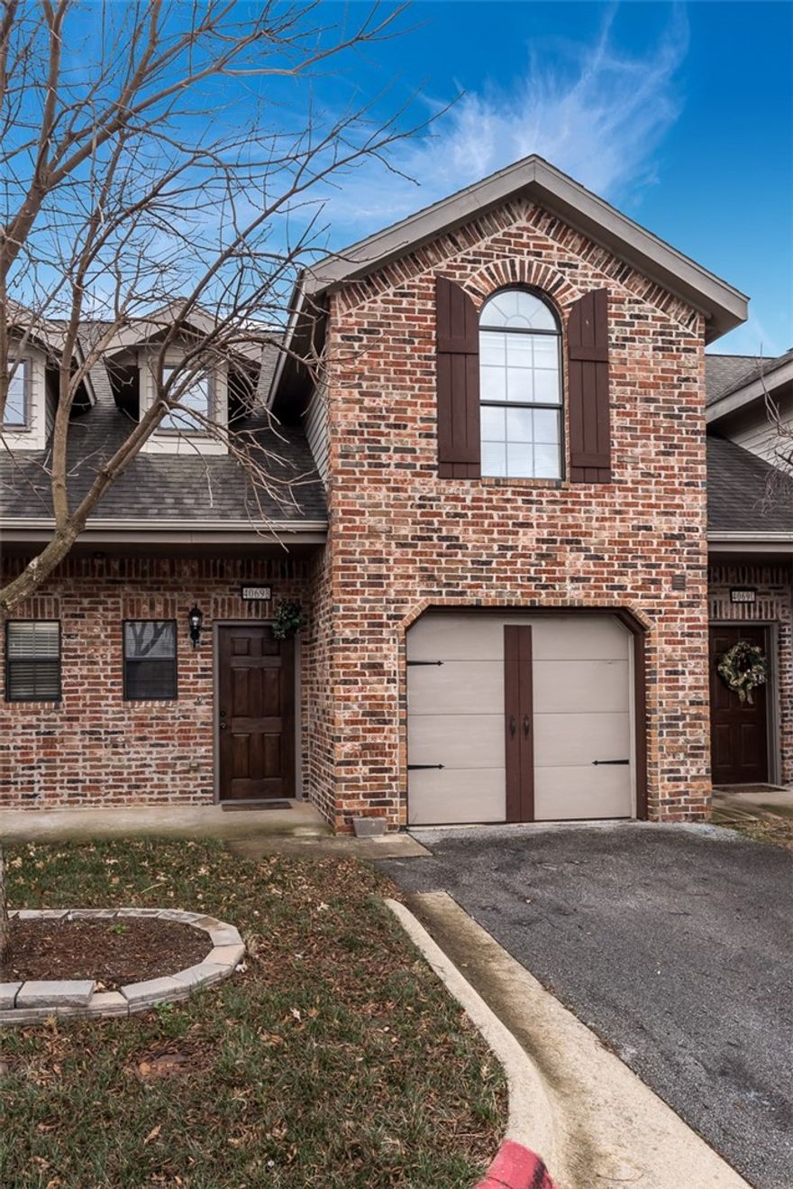 Beautiful European style townhome in excellent location! Centrally located with easy access to I-49 for short travel to all the best NWA has to offer. Close to shopping, dining, and entertainment. Private and quiet community. Townhome features garage parking. This home welcomes you inside with a vaulted entryway and stairway to second story. Entryway leads into the kitchen and dining area that is spacious for entertaining. Pantry adds storage space. Large living room has fireplace and built-in entertainment alcove. Backyard is privacy fenced and has patio for outdoor living space. Upstairs is Master bedroom with walk-in closet and attached bath. Guest bedroom upstairs also has attached bath. This unit is a must see!. All Kitchen appliances, lawn care and trash pick up are included.