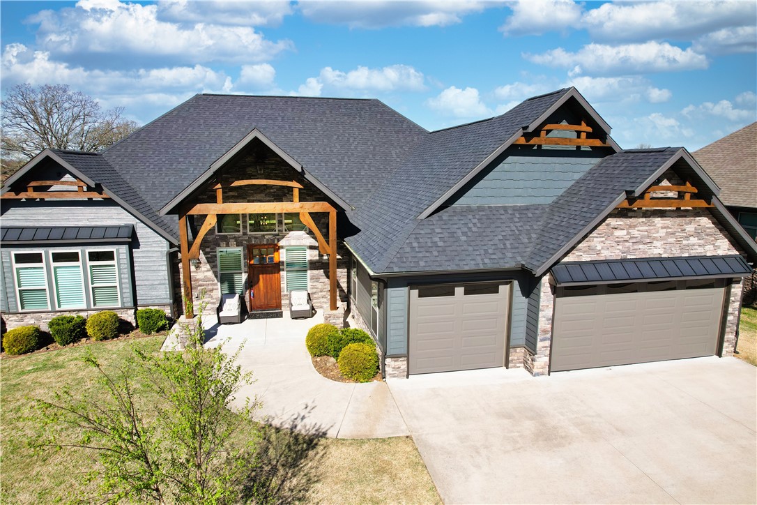 Framed by stone and cedar, this modern rustic beauty stands out with rare design touches. All 4 bedrooms, each with a private bath, plus a half bath, are on one level. The living room features cedar beams, wood-look tile floor, a stacked-stone gas log fireplace, & open floor plan. The kitchen boasts a large island, 5-burner gas stove, custom cabinets, beverage fridge, & an incredible walk-in butlerās pantry with coffee bar. The primary suite is a true retreat with a soaking tub, walk-thru shower with dual heads, dual vanity & a stunning closet with built-ins. Enjoy the covered deck with no rear neighbors. Highlights: new garage doors, fresh exterior paint, new landscaping, tankless water heater, exterior uplighting, irrigation system, central vac, & oversized 3-car garage with attic storage. Cook smores in fireplace or picnic at the community pavilion. Ideally located near I-49, XNA, Bentonville West High, Coler MTB Preserve, and WMT Global Campusāall within 10 minutes. See Feature Sheet for even more information.