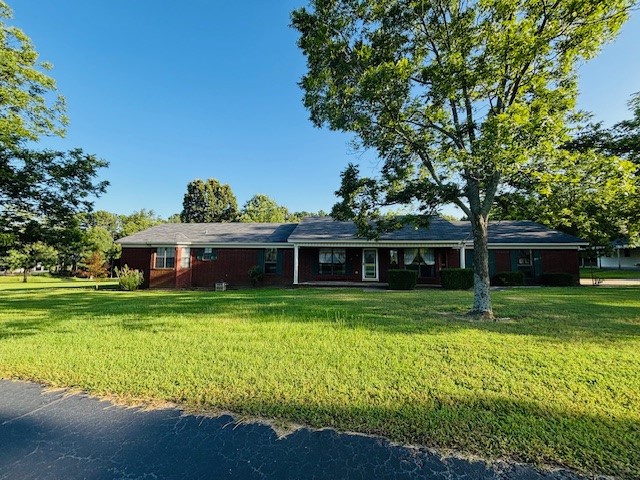 Spacious 4-bedroom, 2-bath home on 3.18 peaceful acres just outside Russellville. Built in 2005 with 2,303 sq ft, this well-maintained home features a large living room with tall ceilings and a cozy wood-burning fireplace. The kitchen and dining area are combined, with the dining space highlighted by a beautiful bay window. The primary suite includes a large bathroom with a soaking tub set into its own bay window, offering a relaxing retreat. A newer roof was installed within the last 4 years. Outside, enjoy a private pond, mature pecan trees, a blacktopped driveway, detached 2-car garage/workshop, and two carports. Some updates and deck repairs needed, giving you the chance to make it your own.