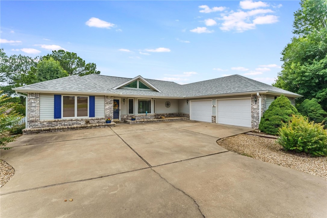 This is the home you won’t want to leave! Beautiful curb appeal with an oversized side-entry 2-car garage with insulated doors, a separate mini split unit and additional shelving, front landscaping, and a lush backyard oasis with an irrigation system. Step inside to a spacious living area with custom built-ins and views of the heated and cooled sunroom. The kitchen is well-appointed and overlooks both the sunroom and a deck with a pergola—perfect for entertaining. You’ll also love the screened-in porch, ideal for relaxing year-round. A versatile office/flex room with beautiful built-ins for added storage. Major updates include a new roof (June 2020) and HVAC system (2021). Located less than 5 minutes from Scottsdale golf course, Lakepoint restaurant and Loch Lomond Marina, as well as the Branchwood Recreation center which offers great amenities including an indoor pool —this home truly has it all! Schedule your showing today!