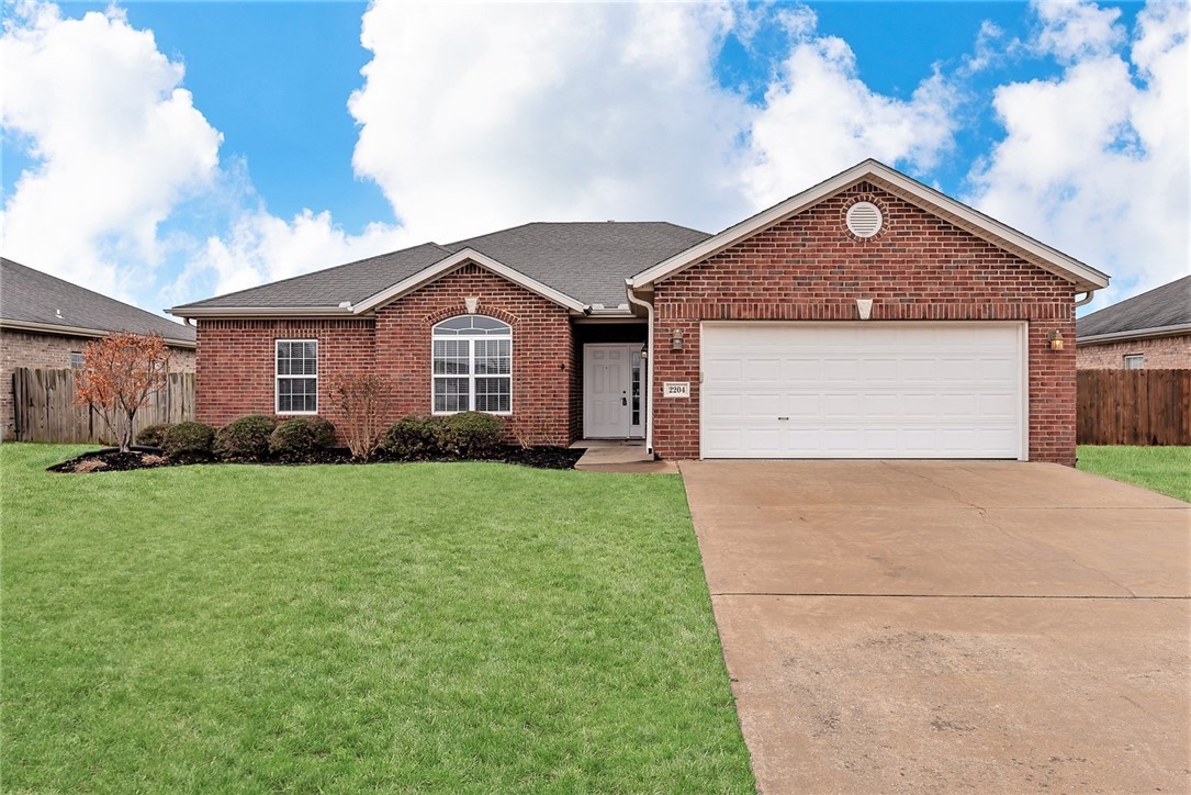 All-brick home in wonderful Bentonville subdivision, near shopping and restaurants! Rich wood cabinetry throughout, as well as elegant crown molding in living room and main bedroom. Main suite bathroom features separate vanities, a jetted tub, and separate shower.