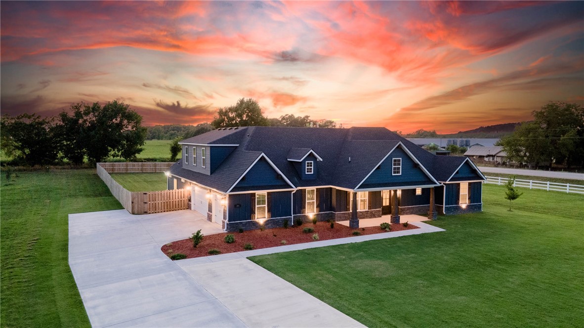 Welcome to Jenna Estates, ideally situated 11 miles from downtown Bentonville & the new Bella Vista Bypass. Enjoy the best of both worlds with easy access to I-49 & a serene country setting on 1.48 acres. Home features include four bedrooms featuring en suite bathrooms & walk-in closets, a spacious study with built-ins, a versatile upstairs bonus room, & a three-car side load garage providing ample space. Modern Farnhouse-style elegance defines the main living areas, showcasing stained beams, built-ins around the stacked stone gas fireplace, shiplap accents, designer lighting, a large island, sizeable pantry, & stainless steel appliances. Stunning Ownerās Suite features a walk-in shower, huge walk-in closet with center island, & soaker tub offering a blissful escape right at home. Outside youāll find a large privacy-fenced backyard & a covered patio-a perfect setting for making memories with family and friends. Don't miss the opportunity to tour this exceptional home and experience its remarkable details firsthand!