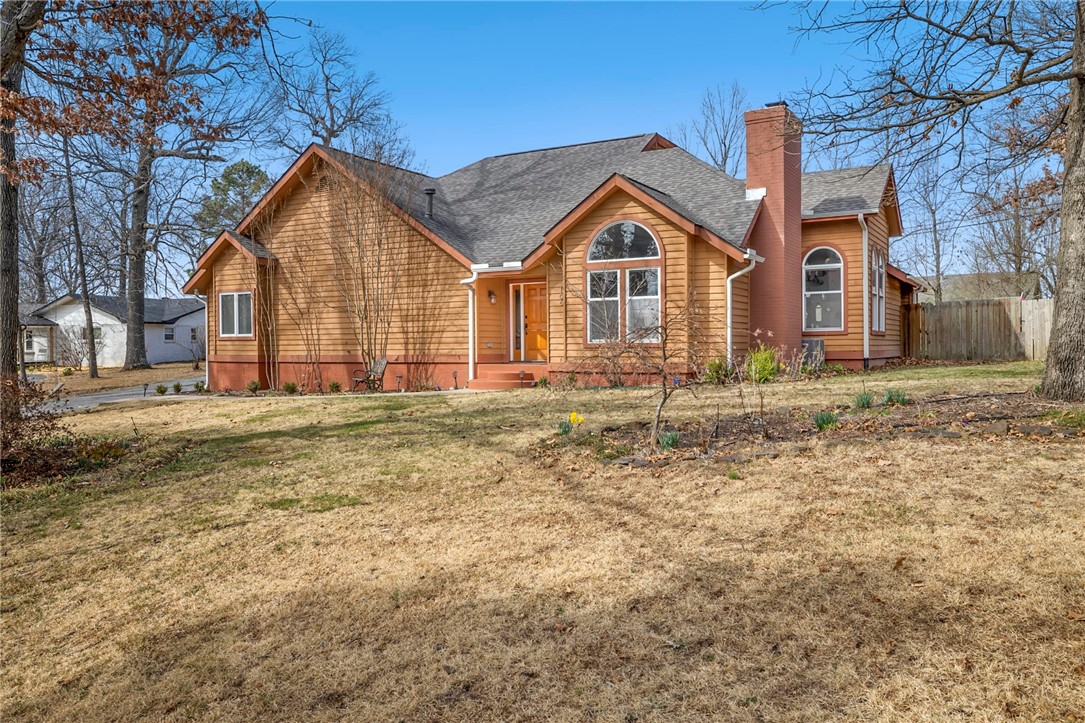 Experience the eclectic charm of this home conveniently located near Lake Fayetteville, equidistant from the Fayetteville square and Downtown Springdale, and the Johnson square dining options. Mature trees and native pollinator gardens create a park-like setting. The living room boasts soaring ceilings and abundant natural light. An eat-in kitchen features granite countertops complete with a built-in breakfast nook with additional storage. A formal dining area located off of the kitchen provides space for hosting along with access to a central atrium adding to the unique character of the home. An additional living room is adorned with wood beams and a fireplace. The spacious primary suite features tall ceilings along with beautiful stone details and a soaking tub in the bathroom. A 3-car detached garage includes a work area and additional storage. Outside, the covered stone patio overlooks the expansive backyard, ideal for entertaining or enjoying peaceful moments completing the ambiance of this eclectic haven.