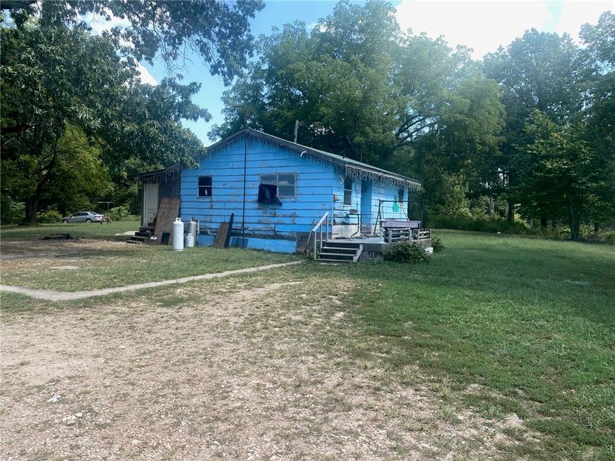 Home is sold as is.  Located on 5 acres this 2-bedroom 1 bath home could be a nice fixer upper.  Lots of property to roam as well as build a shop or a new home on.