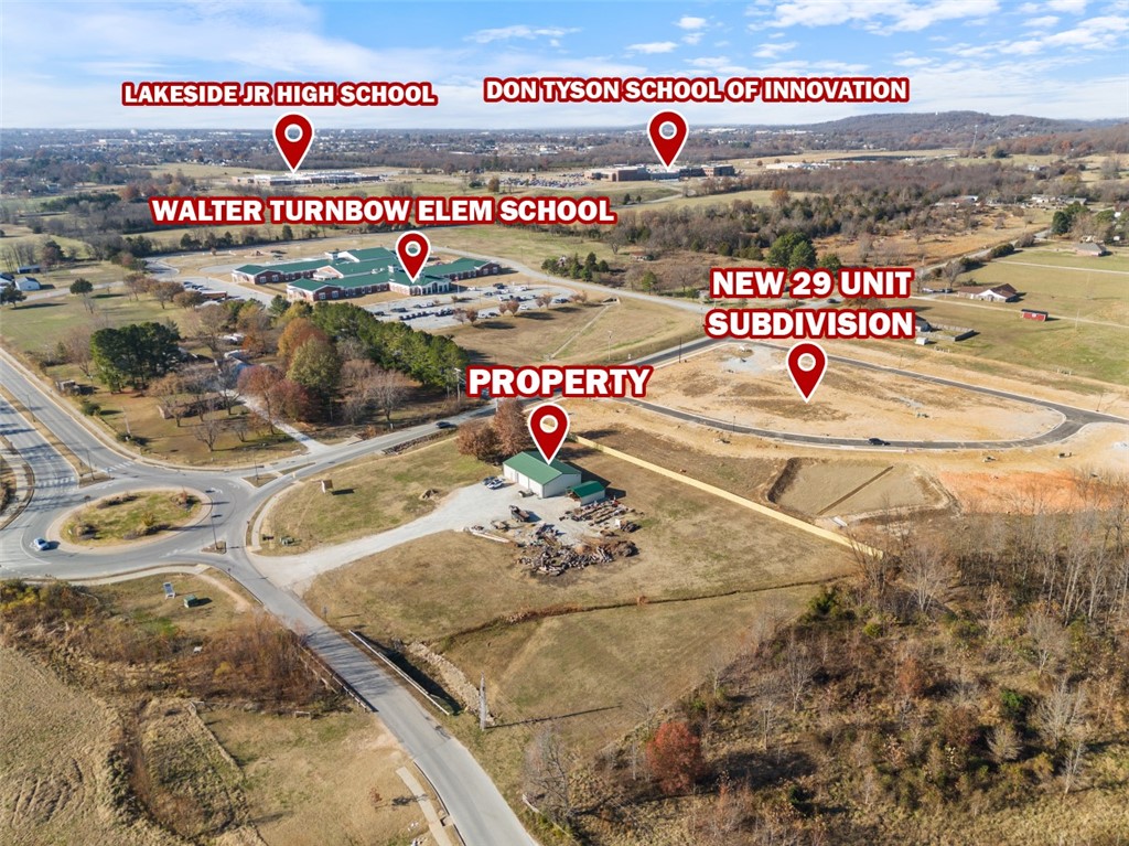 Situated just under a mile from Hwy 412 and directly adjacent to Don Tyson Pkwy, this highly visible
corner lot offers endless commercial possibilities. Zoned C-2 General Commercial District, this site allows
for a broad range of business uses, including convenience stores, health facilities, offices, hardware
stores, auto services, and more! On-site is a versatile 40'x60' warehouse/flex space building, equipped
with Red Iron Beam and Trusses, durable concrete flooring, 19 gallon electric water heater, and 3-phase
electric with existing 220V outlets. The shop also features copper air lines with pressure regulators and
connectors, an insulated 10' overhead door, private office, and a restroom. This property is ideal for
business owners seeking expansion or investors looking for a lucrative development opportunity in
Northwest Arkansas alike.