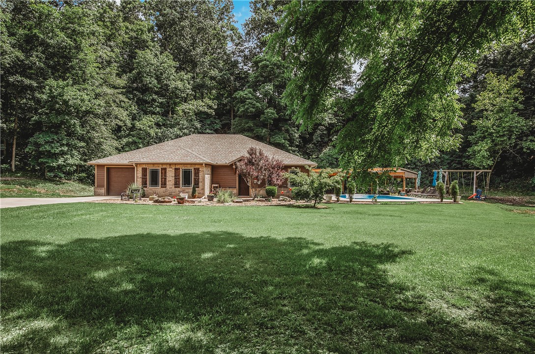 Beautiful 3 bd 2 1/2 bath 2015 constructed home nestled in park-like setting on 6.83 acres both wooded and pasture. Features an in-ground pool constructed in 2020 that is heated. The pool patio area boasts a beautiful large covered pergola and includes a 1/2 bath for perfect outdoor living. This beautiful property has a spring-fed pond, wet weather creek and a 24 x 50 heat and cooled shop with a full bath. Home features geothermal heat and air system, lifetime warranty shingles and concrete reinforced walls.