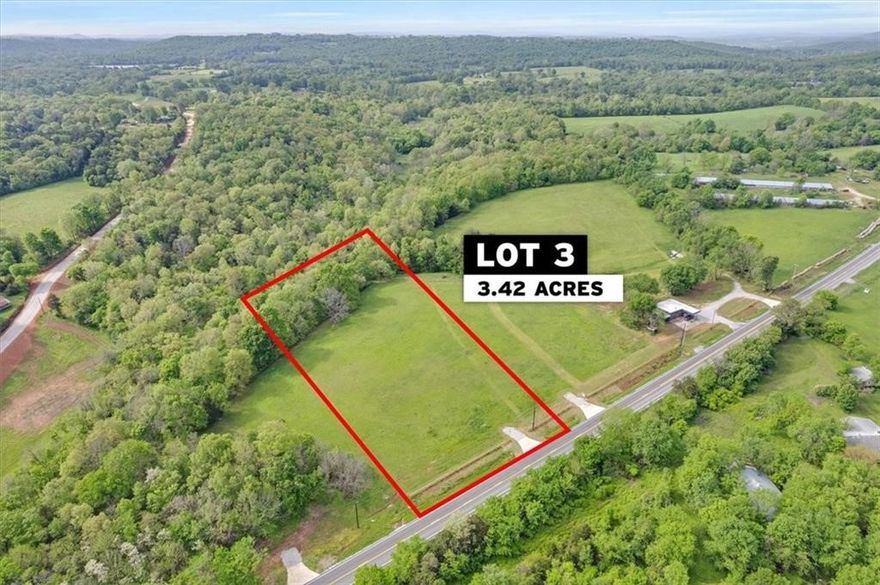 3.42 acre lot, 1/3 wooded, bordering a beautiful creek along the backside of the property.  Front 2/3 of property is an open, manicured pasture ready to build, only 15 minutes to East Fayetteville and Mission, zoned Fayetteville Public Schools.  On site well provided.  Utilities at the road.