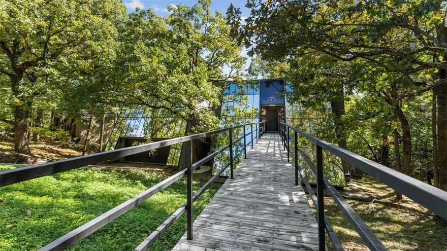 Discover an extraordinary mid-century modern masterpiece on Mt. Sequoyah, crafted by the late, world-renowned architect James Lambeth. This contemporary residence epitomizes luxurious living, boasting sleek lines, modern finishes, and a sophisticated design aesthetic. Originally built in 1973, the home was thoughtfully expanded in 2011, adding 1,100 square feet plus spacious 4 car garage, seamlessly blending style with functionality. The modern kitchen has been tastefully updated in 2022. Experience a unique architectural legacy where timeless design harmonizes with modern comfort. Sweeping views of the wooded lot with mature hardwoods is stunning with plenty of outdoor decking to enjoy the serene surroundings. Perfectly situated minutes from historic downtown Fayetteville, the University of Arkansas, scenic biking trails, parks, a variety of shopping and dining options, this property offers a vibrant yet convenient lifestyle. Priced below appraisal.