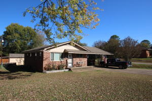 With some new floor covering in some areas, a little paint, this would make a great first time home, or rental. Great space with three bedrooms. Some original hardwood floors, two big carport spaces a fenced back yard with an overlooking deck. Bring your ideas and make this home yours. Nice corner lot with a very quiet neighborhood.